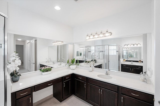 bathroom with a stall shower, tile patterned flooring, and vanity