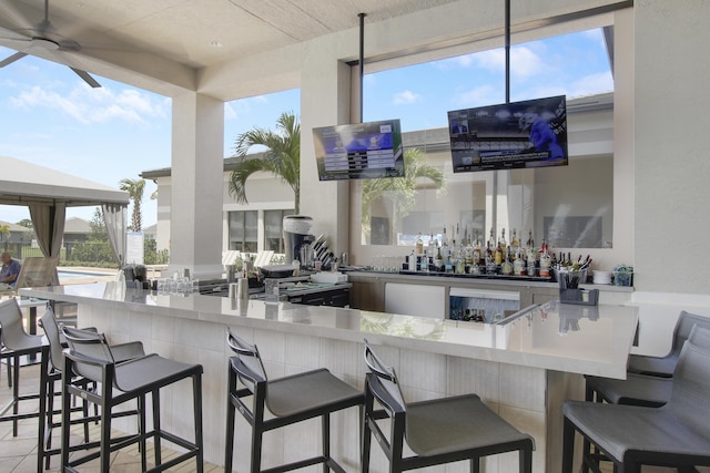 13339 SW River Rock Rd, Port Saint Lucie, FL 34987 - community bar area with ceiling fan and healthy amount of natural light