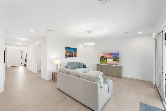 living area featuring light tile patterned floors, recessed lighting, and baseboards