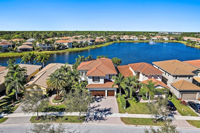aerial view of residential area featuring a large body of water
