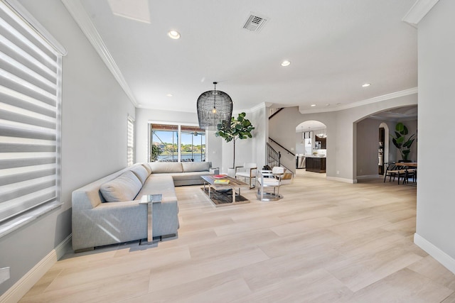 living area with arched walkways, ornamental molding, baseboards, recessed lighting, and stairs