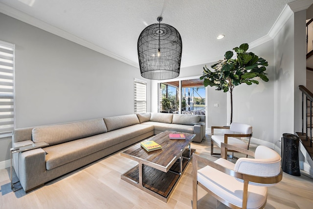 living area with ornamental molding, light wood-style flooring, stairway, a textured ceiling, and recessed lighting