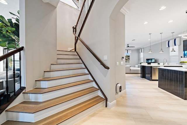 stairs featuring arched walkways, recessed lighting, baseboards, and ornamental molding