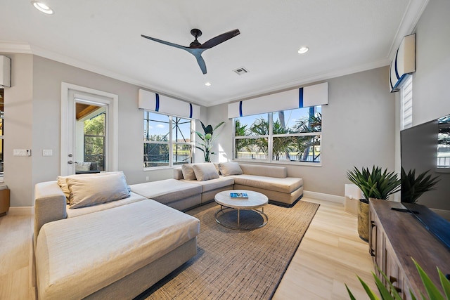 living room featuring recessed lighting, crown molding, ceiling fan, light wood-style floors, and baseboards