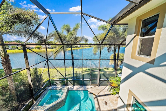 view of pool featuring a water view, a lanai, a pool with connected hot tub, and a patio