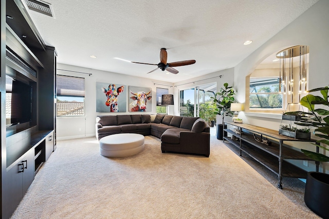 living room featuring carpet, a ceiling fan, baseboards, recessed lighting, and a textured ceiling