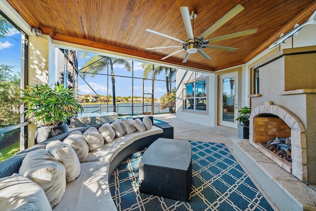 view of patio featuring ceiling fan, an outdoor hangout area, and a water view