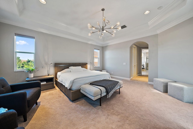bedroom featuring a raised ceiling, light colored carpet, ornamental molding, arched walkways, and a chandelier