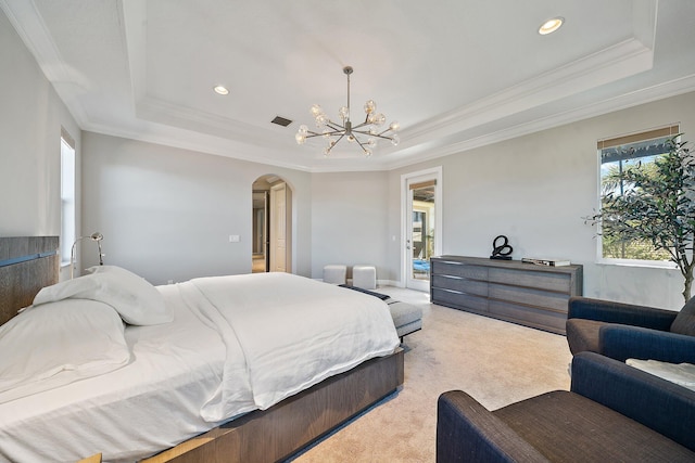 bedroom featuring a raised ceiling, crown molding, a chandelier, arched walkways, and light carpet