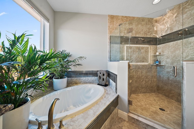 full bathroom with a garden tub and a shower stall