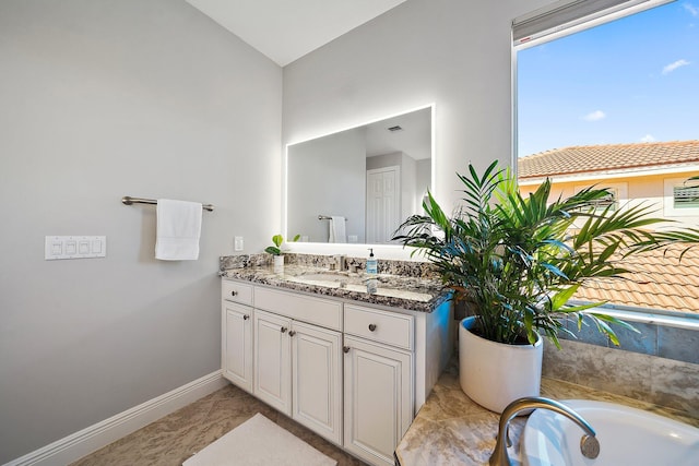 full bathroom featuring baseboards, vanity, lofted ceiling, a bath, and marble finish floors