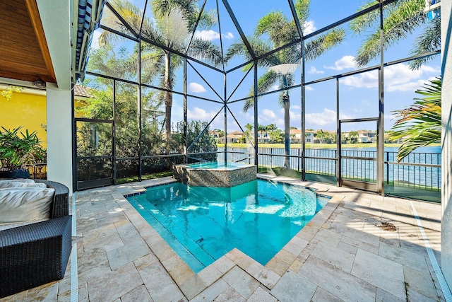 view of pool with a patio, a lanai, a pool with connected hot tub, and a water view
