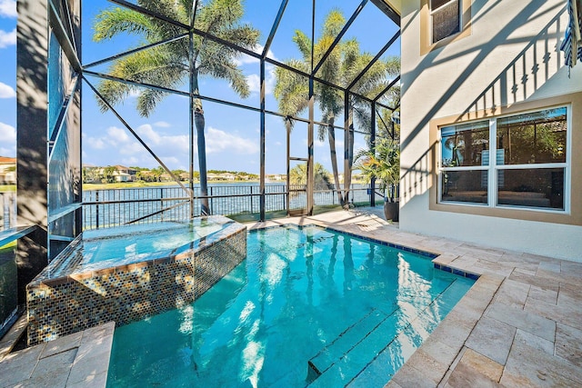 view of pool with glass enclosure, a patio, a pool with connected hot tub, and a water view