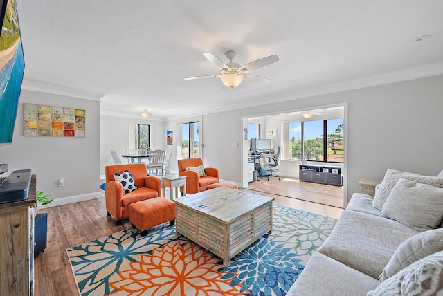 5393 SE Miles Grant Rd Unit A203, Stuart, FL 34997 - living area featuring crown molding, healthy amount of natural light, light wood-type flooring, and ceiling fan