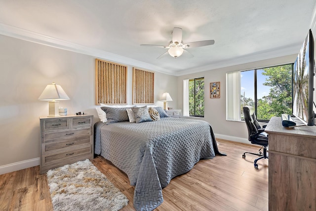 5393 SE Miles Grant Rd Unit A203, Stuart, FL 34997 - bedroom with baseboards, crown molding, an office area, light wood-style flooring, and a ceiling fan