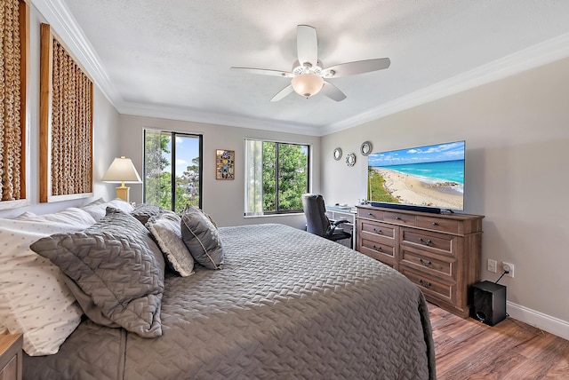 5393 SE Miles Grant Rd Unit A203, Stuart, FL 34997 - bedroom with wood finished floors, ornamental molding, baseboards, ceiling fan, and a desk