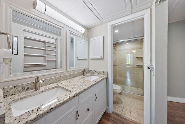 5393 SE Miles Grant Rd Unit A203, Stuart, FL 34997 - full bathroom featuring toilet, a stall shower, double vanity, baseboards, and wood finished floors