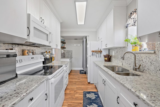 5393 SE Miles Grant Rd Unit A203, Stuart, FL 34997 - kitchen with white appliances, a sink, ornamental molding, white cabinetry, and backsplash
