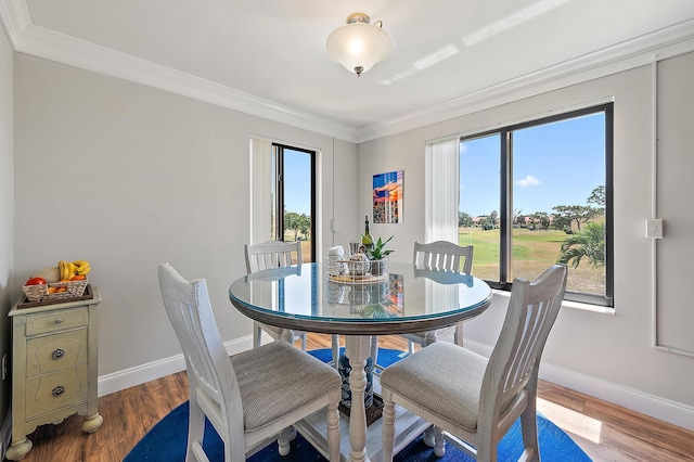 5393 SE Miles Grant Rd Unit A203, Stuart, FL 34997 - dining room with ornamental molding, baseboards, wood finished floors, and view of golf course