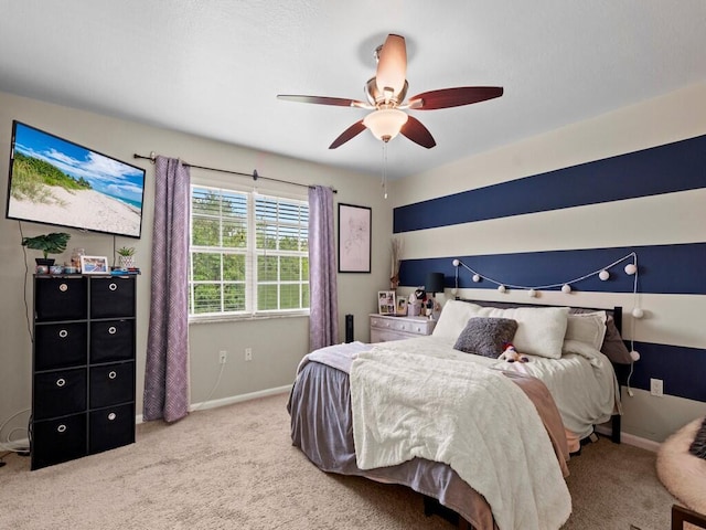 carpeted bedroom with baseboards and a ceiling fan