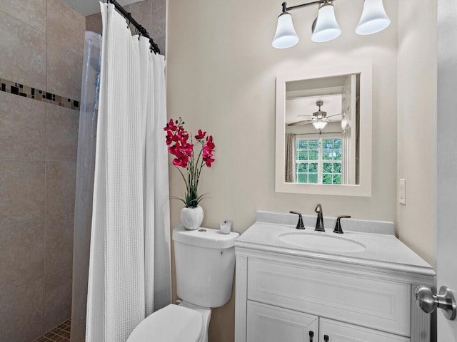 bathroom featuring toilet, a tile shower, and vanity