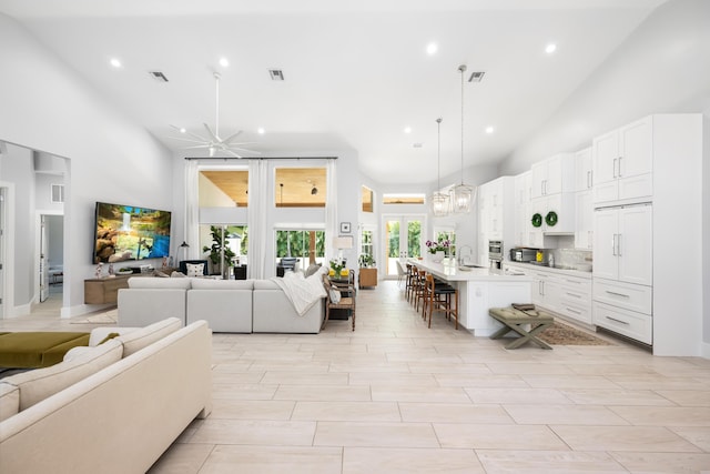 living room with high vaulted ceiling and recessed lighting