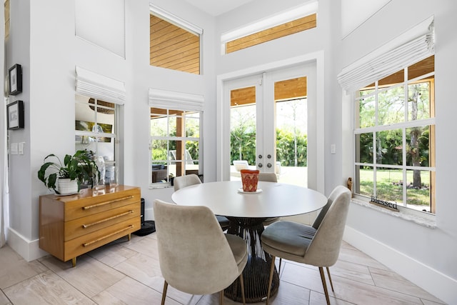 sunroom / solarium featuring french doors and healthy amount of natural light