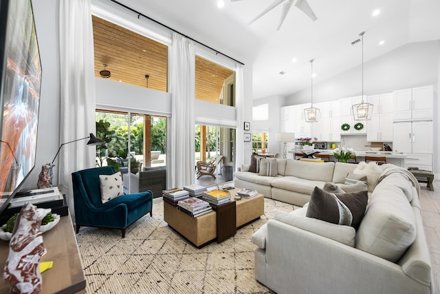 living room with high vaulted ceiling, ceiling fan, and recessed lighting