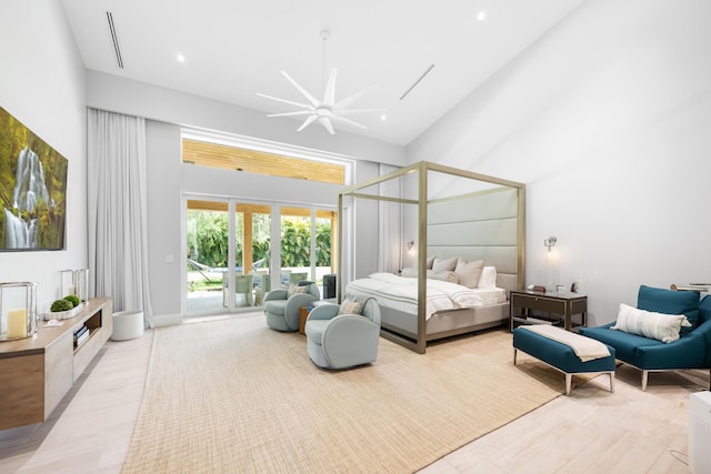bedroom featuring access to exterior, a high ceiling, light wood-style floors, recessed lighting, and ceiling fan
