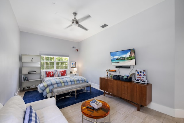 bedroom with baseboards, wood finished floors, and a ceiling fan