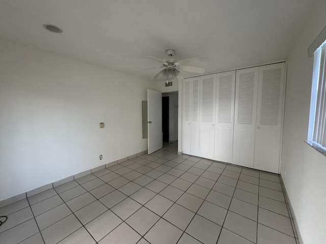 unfurnished bedroom with a ceiling fan, a closet, and light tile patterned flooring