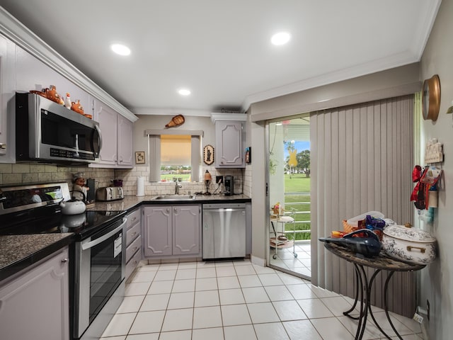 3755 Via Poinciana Unit 203, Lake Worth, FL 33467 - kitchen with appliances with stainless steel finishes, a sink, dark countertops, gray cabinets, and decorative backsplash