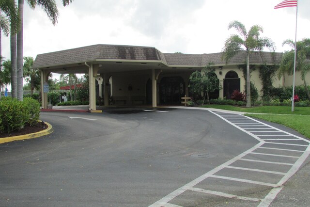 3755 Via Poinciana Unit 203, Lake Worth, FL 33467 - view of vehicle parking featuring driveway