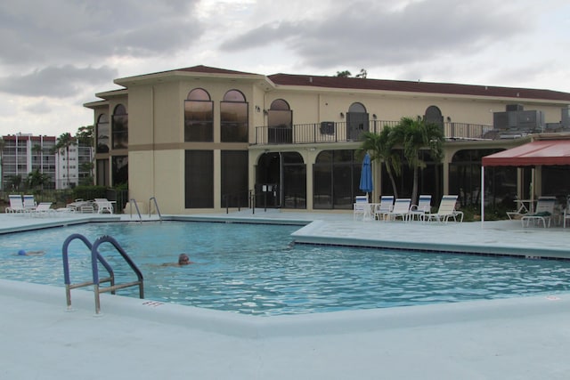 3755 Via Poinciana Unit 203, Lake Worth, FL 33467 - community pool featuring a patio area