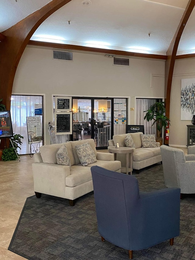3755 Via Poinciana Unit 203, Lake Worth, FL 33467 - living room with arched walkways and a towering ceiling