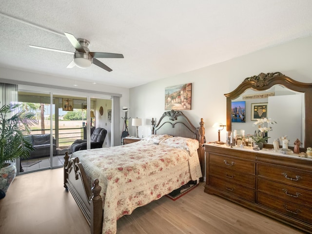 3755 Via Poinciana Unit 203, Lake Worth, FL 33467 - bedroom with access to outside, wood finished floors, and a ceiling fan