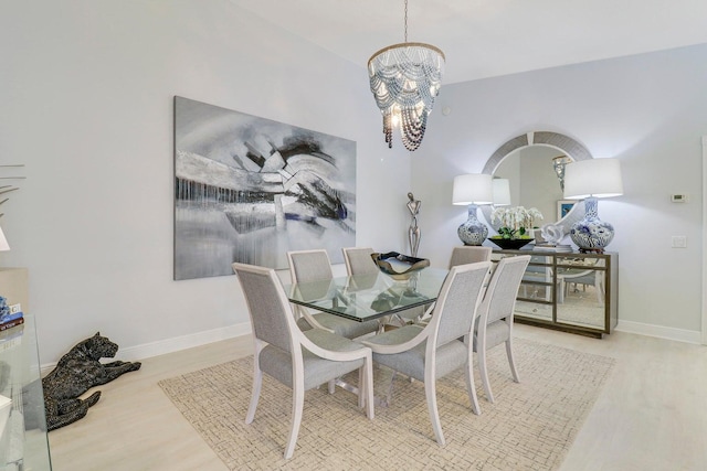5021 Magnolia Bay Cir, Palm Beach Gardens, FL 33418 - dining room with wood finished floors, a chandelier, and baseboards