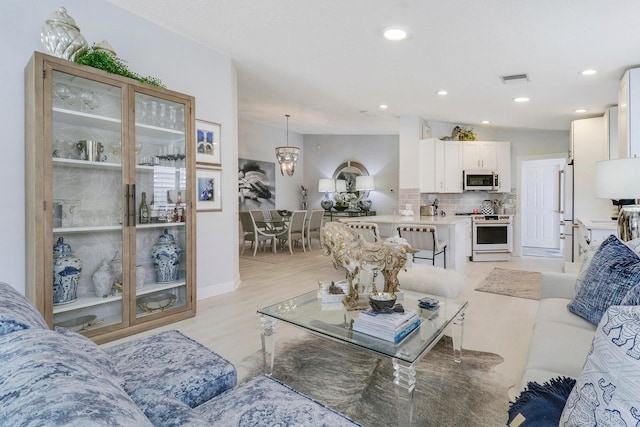 5021 Magnolia Bay Cir, Palm Beach Gardens, FL 33418 - living room with recessed lighting and light wood-type flooring