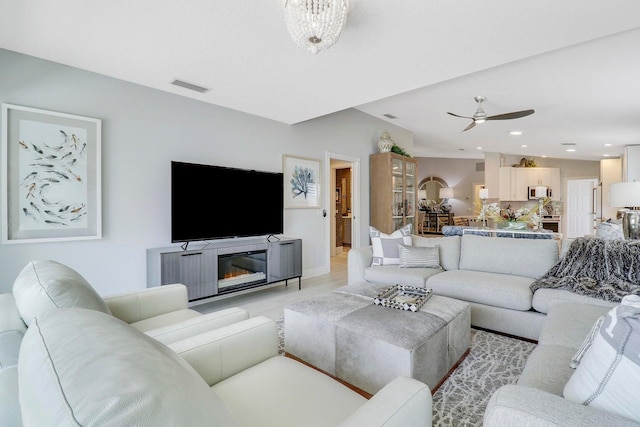 5021 Magnolia Bay Cir, Palm Beach Gardens, FL 33418 - living room with a ceiling fan, light wood finished floors, recessed lighting, and baseboards