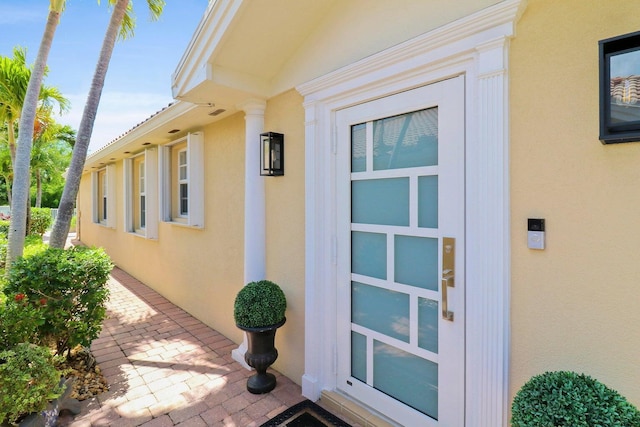 5021 Magnolia Bay Cir, Palm Beach Gardens, FL 33418 - view of exterior entry featuring stucco siding