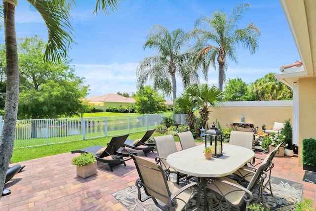 5021 Magnolia Bay Cir, Palm Beach Gardens, FL 33418 - view of patio with outdoor dining space and a fenced backyard