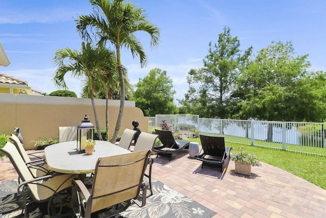 5021 Magnolia Bay Cir, Palm Beach Gardens, FL 33418 - view of patio featuring a fenced backyard and outdoor dining area