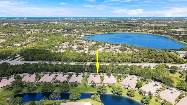 5021 Magnolia Bay Cir, Palm Beach Gardens, FL 33418 - aerial view of property and surrounding area with nearby suburban area, a nearby body of water, and a tree filled landscape