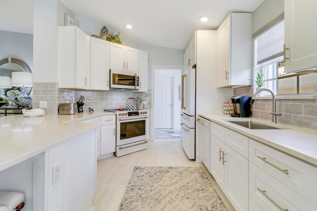 5021 Magnolia Bay Cir, Palm Beach Gardens, FL 33418 - kitchen with white appliances, a sink, white cabinets, and recessed lighting