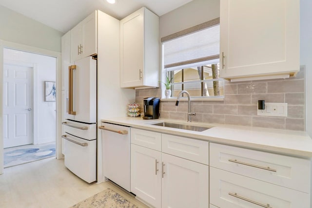 5021 Magnolia Bay Cir, Palm Beach Gardens, FL 33418 - kitchen featuring white appliances, a sink, decorative backsplash, and white cabinets