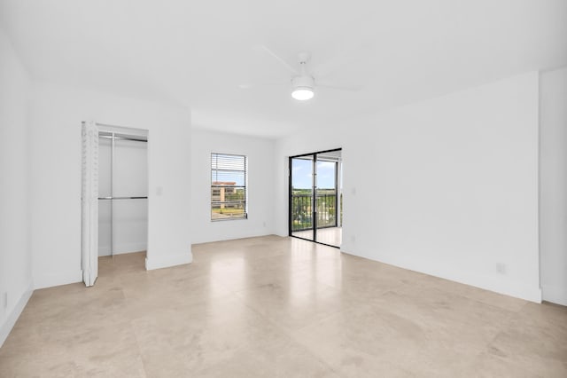 unfurnished bedroom featuring access to outside and a ceiling fan