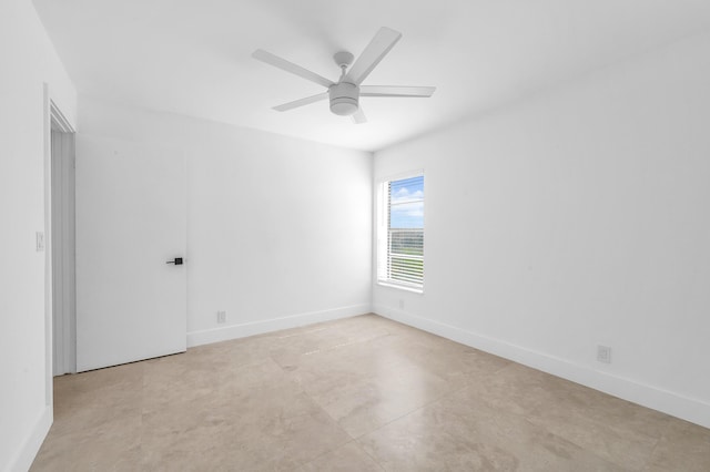 unfurnished room with a ceiling fan, baseboards, and concrete floors
