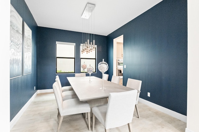 8640 E Baypoint Cir, Parkland, FL 33076 - dining space with baseboards, a chandelier, and light tile patterned flooring