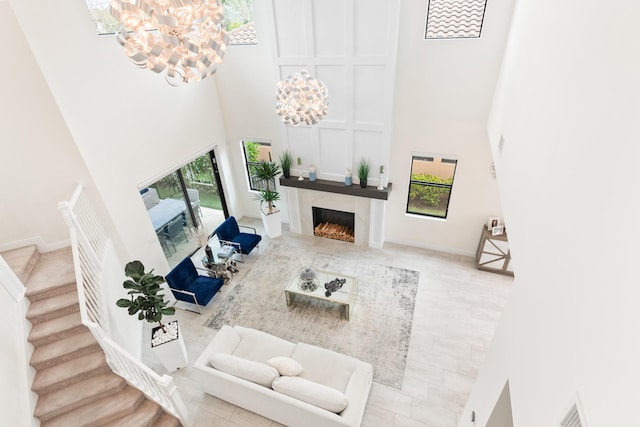 8640 E Baypoint Cir, Parkland, FL 33076 - living area with a towering ceiling, a chandelier, healthy amount of natural light, and stairs