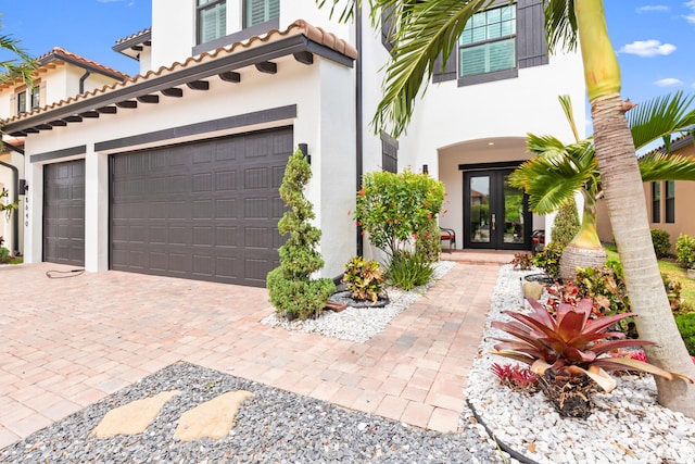 8640 E Baypoint Cir, Parkland, FL 33076 - view of front of house with french doors, a garage, decorative driveway, and stucco siding